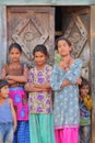 BUNDI, RAJASTHAN, INDIA - DECEMBER 09, 2017: Portrait of three teenage girls and two children posing at the entrance of a house in