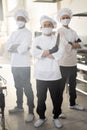 Portrait of chef cooks with different ethnicities standing together in restaurant kitchen Royalty Free Stock Photo