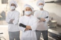 Portrait of chef cooks with different ethnicities standing together in restaurant kitchen Royalty Free Stock Photo