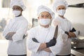 Portrait of chef cooks with different ethnicities standing together in restaurant kitchen Royalty Free Stock Photo