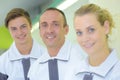 Portrait three workers in matching uniforms