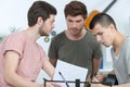 Portrait three young musicians conferring