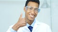 Portrait of Thumbs Up by Scientist, Doctor, Surgeon in Protective Glasses