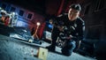 Portrait Tilted Shot of Male Asian Police Officer Taking Forensic Photos of Evidence Found Next