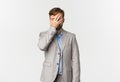 Portrait of tired and annoyed bearded businessman in grey suit, facepalming, slap his face and standing distressed over