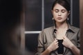 Portrait of a tired businesswoman looking in the mirror, reflection of a beautiful young woman getting ready for work, concept Royalty Free Stock Photo