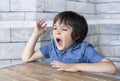 Portrait tired child yawning, Little boy get a cold during weather change, Child having allergy.  kid has reflection or hay fever Royalty Free Stock Photo