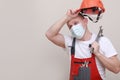 portrait of tired engineer worker or mechanic wearing helmet and face mask for protect virus covid 19 on white Royalty Free Stock Photo