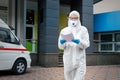 Portrait of tired exhausted female doctor, scientist or nurse wearing face mask and biological hazmat ppe suit reading who Royalty Free Stock Photo