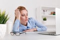 Portrait of tired office woman working by computer. Laptop problem. Royalty Free Stock Photo