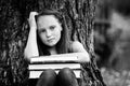 Portrait of tired teen girl with books in the park. Black and white photo. Royalty Free Stock Photo