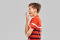 Portrait of tired yawning boy in red polo t-shirt