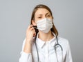 Portrait of tired young doctor taking off medical face mask Royalty Free Stock Photo