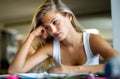 Portrait of tired young female studying in a library. Education study teenager concept Royalty Free Stock Photo