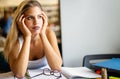 Portrait of tired young female studying in a library. Education study teenager concept Royalty Free Stock Photo