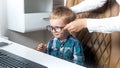 Portrait of cute toddler boy sitting in office chair and wearing eyeglasses Royalty Free Stock Photo