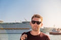 Portrait of tourist man in sunglasses standing in front of big cruise ship in port of Bar, Montenegro on Adriatic sea Royalty Free Stock Photo