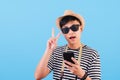 Portrait of a tourist wearing a black and white striped shirt, isolated on a blue background Royalty Free Stock Photo