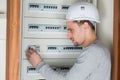 portrait tradesman repairing fuseboard