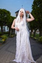 Portrait of Tranquil Caucasian Female Bride Wearing Diadem and Long Hair. Posing Against Old Church Building Outdoors Royalty Free Stock Photo