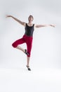 Portrait of Tranquil Contemporary Ballet of Flexible Athletic Man Posing in Red Tights in Ballanced Dance Pose With Hands In Line