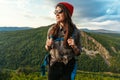 Portrait of a traveler in tourist gear. A young tourist with a backpack admires the sunset from the top of the mountain. Tourist Royalty Free Stock Photo