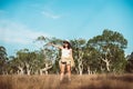 Portrait of traveler young asian woman standing and pointing something on sunset time in the forest,Happy and smiling,Relaxing tim Royalty Free Stock Photo