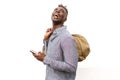 Traveling african man walking with mobile phone looking away and laughing Royalty Free Stock Photo