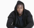 Portrait of a trendy African American man wearing hooded sweatshirt over gray background