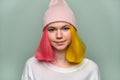 Portrait of trendy teenager girl with colored dyed hair in knitted hat Royalty Free Stock Photo