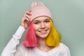 Portrait of trendy teenager girl with colored dyed hair in knitted hat Royalty Free Stock Photo