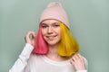 Portrait of trendy teenager girl with colored dyed hair in knitted hat Royalty Free Stock Photo