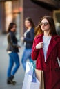 Portrait of trendy woman with shopping bags