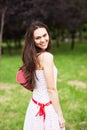 Portrait of trendy young woman in funky white dress smiling Royalty Free Stock Photo