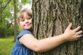 A portrait of trisomie 21 child girl outside having fun on a park