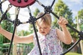 A portrait of trisomie 21 child girl outside having fun on a park