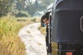 Portrait of tuk tuk driver on rural road