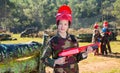 Girl paintball player in camouflage standing Royalty Free Stock Photo