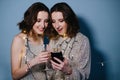 Portrait of twin sisters, they chat on the phone Royalty Free Stock Photo