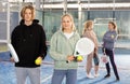Portrait of two teenage tennis players standing holding padel rackets and balls Royalty Free Stock Photo