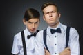 Portrait of two angry boys isolated on gray background. Negative human emotion, facial expression. Closeup Royalty Free Stock Photo