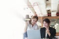 A portrait of two Asian business woman showing joy from sales of new projects that meet customer demand Royalty Free Stock Photo