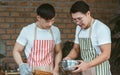 Portrait of two asian handsome men cooking together in kitchen room at home. Lifestyle, Friendship and LBGT Concept Royalty Free Stock Photo