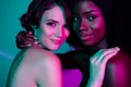 Portrait of two attractive alluring lovable women hugging romance isolated over vivid gradient neon color background Royalty Free Stock Photo