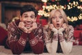 Portrait of two attractive amazed married spouses lying on carpet holly jolly sudden news reaction spending day December