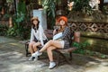 portrait of two attractive women local tourists sitting down to rest