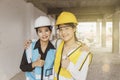 The portrait embraces the bond between a female architect supervisor and a subordinate on a construction site. Royalty Free Stock Photo