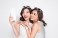 Portrait of two beautiful asian fashionable women taking selfie Royalty Free Stock Photo