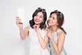 Portrait of two beautiful asian fashionable women taking selfie Royalty Free Stock Photo