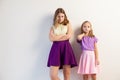 Portrait of two beautiful fashionable sisters girls on a white background Royalty Free Stock Photo